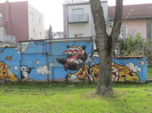 Prešaran mural Lunara i njegovih prijatelja na ogradi uz Autoput u Srednjacima. [VR 2022.]